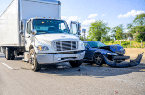 Collision of a semi truck with box trailer a passenger car